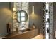 Modern bathroom features a unique sink, stylish mirror, and decorative accents at 5630 E Rockridge Rd, Phoenix, AZ 85018