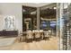 Elegant dining room with large windows, wine storage, and hardwood floors at 5630 E Rockridge Rd, Phoenix, AZ 85018