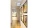 Light-filled hallway adorned with modern artwork and hardwood floors at 5630 E Rockridge Rd, Phoenix, AZ 85018