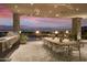 Outdoor dining area with long table and city view at 5630 E Rockridge Rd, Phoenix, AZ 85018