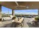 Covered patio with built-in grill, dining table, and stunning views at 5630 E Rockridge Rd, Phoenix, AZ 85018