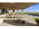 Expansive patio with a large pool, outdoor kitchen, and dining area at 5630 E Rockridge Rd, Phoenix, AZ 85018