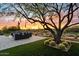 Landscaped backyard with seating area and sunset views at 6450 E Bent Tree Dr, Scottsdale, AZ 85266