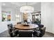 Elegant dining room with a large round table and modern chandelier at 6450 E Bent Tree Dr, Scottsdale, AZ 85266
