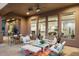 Covered patio with comfortable seating and views of the interior at 6450 E Bent Tree Dr, Scottsdale, AZ 85266