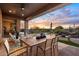 Outdoor patio with seating area, dining table, and sunset views at 6450 E Bent Tree Dr, Scottsdale, AZ 85266