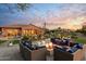 Large backyard patio with firepit and comfortable seating at 6450 E Bent Tree Dr, Scottsdale, AZ 85266