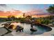 Stunning pool and spa surrounded by lush landscaping at sunset at 6450 E Bent Tree Dr, Scottsdale, AZ 85266