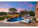 Relaxing pool with waterfall feature and lounge chairs at 6450 E Bent Tree Dr, Scottsdale, AZ 85266