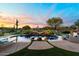 Inviting pool and spa with a waterfall feature and expansive patio at 6450 E Bent Tree Dr, Scottsdale, AZ 85266