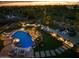 Expansive pool and patio area beautifully lit at night at 6450 E Bent Tree Dr, Scottsdale, AZ 85266