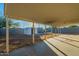 Covered patio and storage shed in a sunny backyard at 1025 S Lola Ln, Tempe, AZ 85281