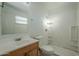Clean bathroom features a shower, toilet, and vanity with a wood cabinet at 1025 S Lola Ln, Tempe, AZ 85281