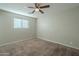 Spacious bedroom with ceiling fan and carpeted floor at 1025 S Lola Ln, Tempe, AZ 85281