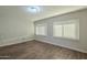 Simple bedroom with hardwood floors and window blinds at 1025 S Lola Ln, Tempe, AZ 85281