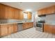 Kitchen with wood cabinets, stainless steel appliances, and tiled floors at 1025 S Lola Ln, Tempe, AZ 85281