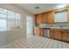 Kitchen features wood cabinets, a window, and tiled floors at 1025 S Lola Ln, Tempe, AZ 85281
