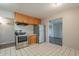 Kitchen area with wood cabinets, stainless steel appliances and tiled floor at 1025 S Lola Ln, Tempe, AZ 85281
