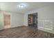Open living room showcasing wood-look floors and kitchen access at 1025 S Lola Ln, Tempe, AZ 85281