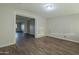 Bright living room with wood-look floors and view into adjacent room at 1025 S Lola Ln, Tempe, AZ 85281