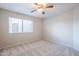 Bright bedroom with carpeted floor, ceiling fan, and window with blinds at 11806 N 40Th Pl, Phoenix, AZ 85028