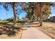 Paved path meanders through lush landscaping, offering scenic views of the golf course and community at 11806 N 40Th Pl, Phoenix, AZ 85028