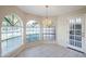 Spacious dining area with arched windows and a chandelier at 11806 N 40Th Pl, Phoenix, AZ 85028