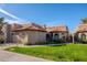 Spanish style home with a two-car garage and manicured lawn at 11806 N 40Th Pl, Phoenix, AZ 85028