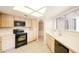 Kitchen boasting black appliances and light wood cabinets at 11806 N 40Th Pl, Phoenix, AZ 85028