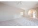 Open living room with high ceilings, arched entryway and neutral color palette at 11806 N 40Th Pl, Phoenix, AZ 85028