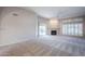 Bright living room with fireplace, sliding glass doors, and plantation shutters at 11806 N 40Th Pl, Phoenix, AZ 85028