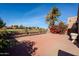 Brick patio with golf course view and red flowering bush at 11806 N 40Th Pl, Phoenix, AZ 85028