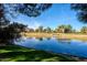 Peaceful pond with clear reflections of the sky and surrounding trees at 11806 N 40Th Pl, Phoenix, AZ 85028
