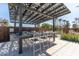 Outdoor kitchen with grill and seating under pergola at 1372 W Crane Dr, Chandler, AZ 85286
