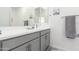 Modern bathroom with gray vanity, double sinks, and a large mirror at 1372 W Crane Dr, Chandler, AZ 85286