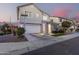 Two-story house with gray siding, stone accents, and a two-car garage at 1372 W Crane Dr, Chandler, AZ 85286