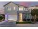 Two-story home with gray siding, stone accents, and a two-car garage at 1372 W Crane Dr, Chandler, AZ 85286
