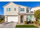 Two-story home with gray siding, stone accents, and a two-car garage at 1372 W Crane Dr, Chandler, AZ 85286