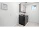 Laundry room with washer, dryer, and cabinets at 1372 W Crane Dr, Chandler, AZ 85286