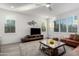 Spacious living area featuring a modern coffee table and TV at 1372 W Crane Dr, Chandler, AZ 85286