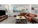 Bright living room with leather sectional sofa and large windows at 1372 W Crane Dr, Chandler, AZ 85286