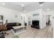 Bright living room with wood-look floors, comfy seating, and a large TV at 1372 W Crane Dr, Chandler, AZ 85286
