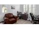 Home office with leather chair and built-in shelving at 1372 W Crane Dr, Chandler, AZ 85286