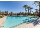 Community pool with lounge chairs and palm trees at 1372 W Crane Dr, Chandler, AZ 85286