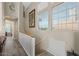 Upstairs hallway with staircase, wood-look floors, and artwork at 1633 E Lakeside Dr # 113, Gilbert, AZ 85234