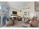Living room with fireplace, wood-look floors, and sliding glass doors at 1633 E Lakeside Dr # 113, Gilbert, AZ 85234