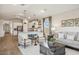 Open living room and kitchen area, featuring a neutral color scheme and ample natural light at 16590 N Dante Way, Maricopa, AZ 85138