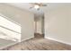 Bright bedroom with wood-look floors and access to hallway at 17470 N 170Th N Ln, Surprise, AZ 85374