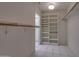 Large walk-in closet with shelving and hanging rods at 17827 N Conquistador Dr, Sun City West, AZ 85375