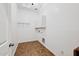 Laundry room with tile floor and overhead storage at 18332 W Cinnabar Ave, Waddell, AZ 85355